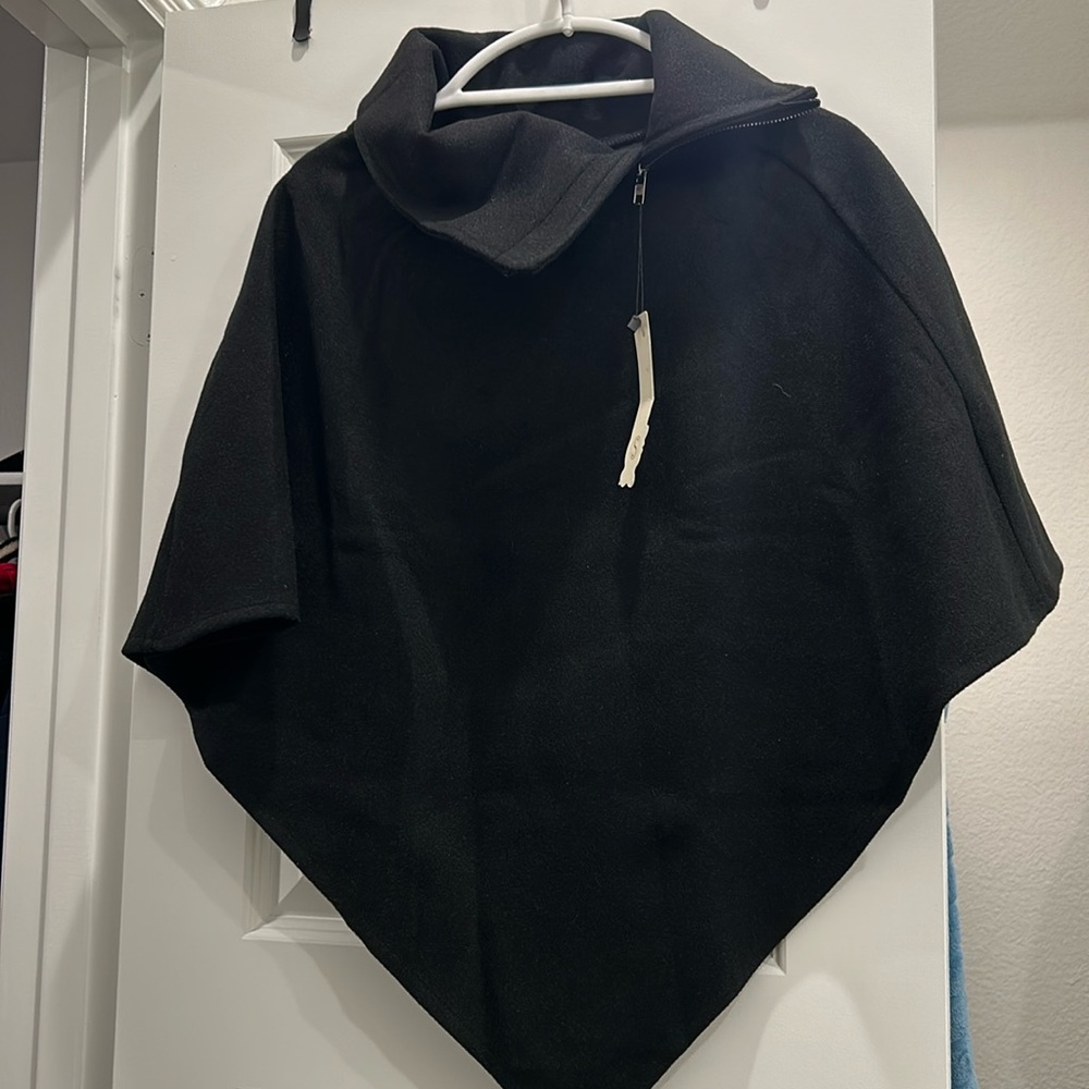 Black cape jacket with zip top collar. Size Small. Never worn. Got as a gift.